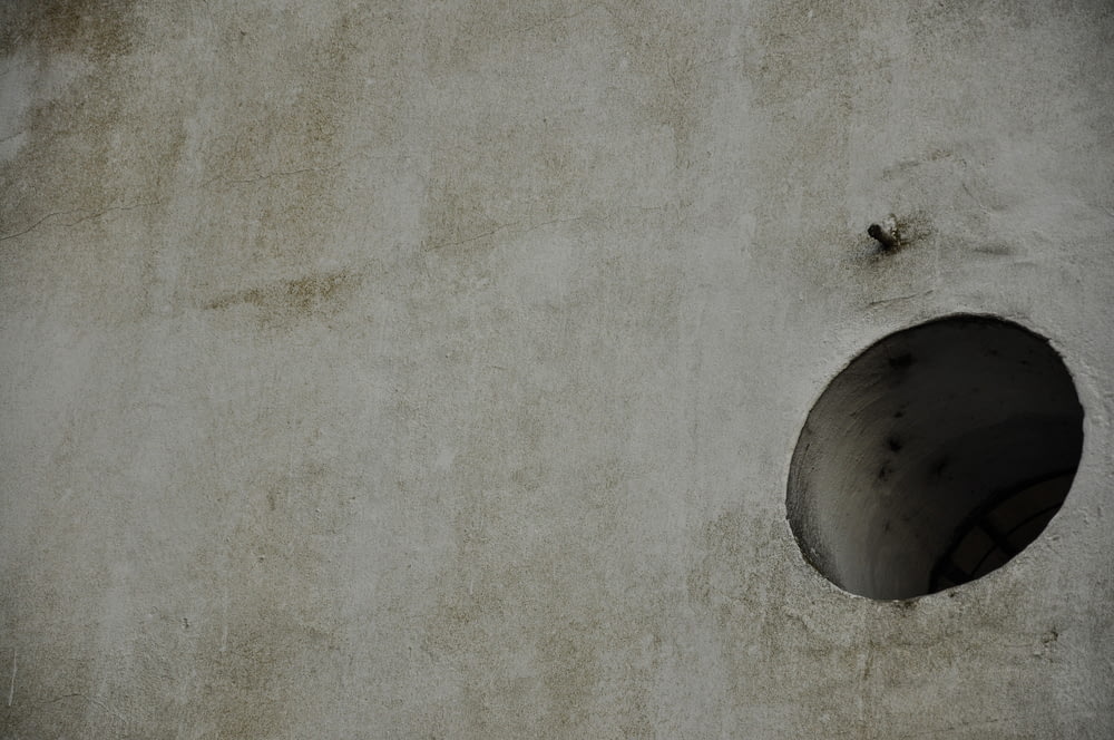 a cement wall with a hole in the middle