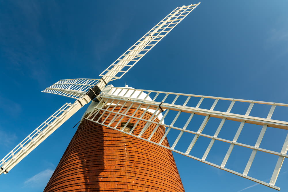 a windmill is shown against a blue sky