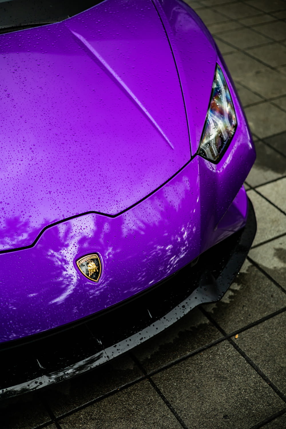a purple sports car parked on the side of the road