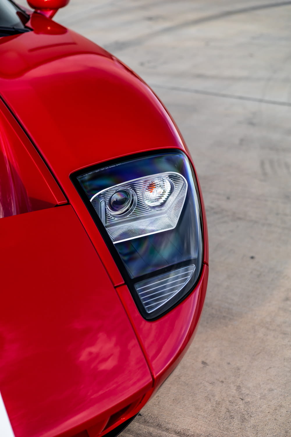 a close up of a red sports car headlight