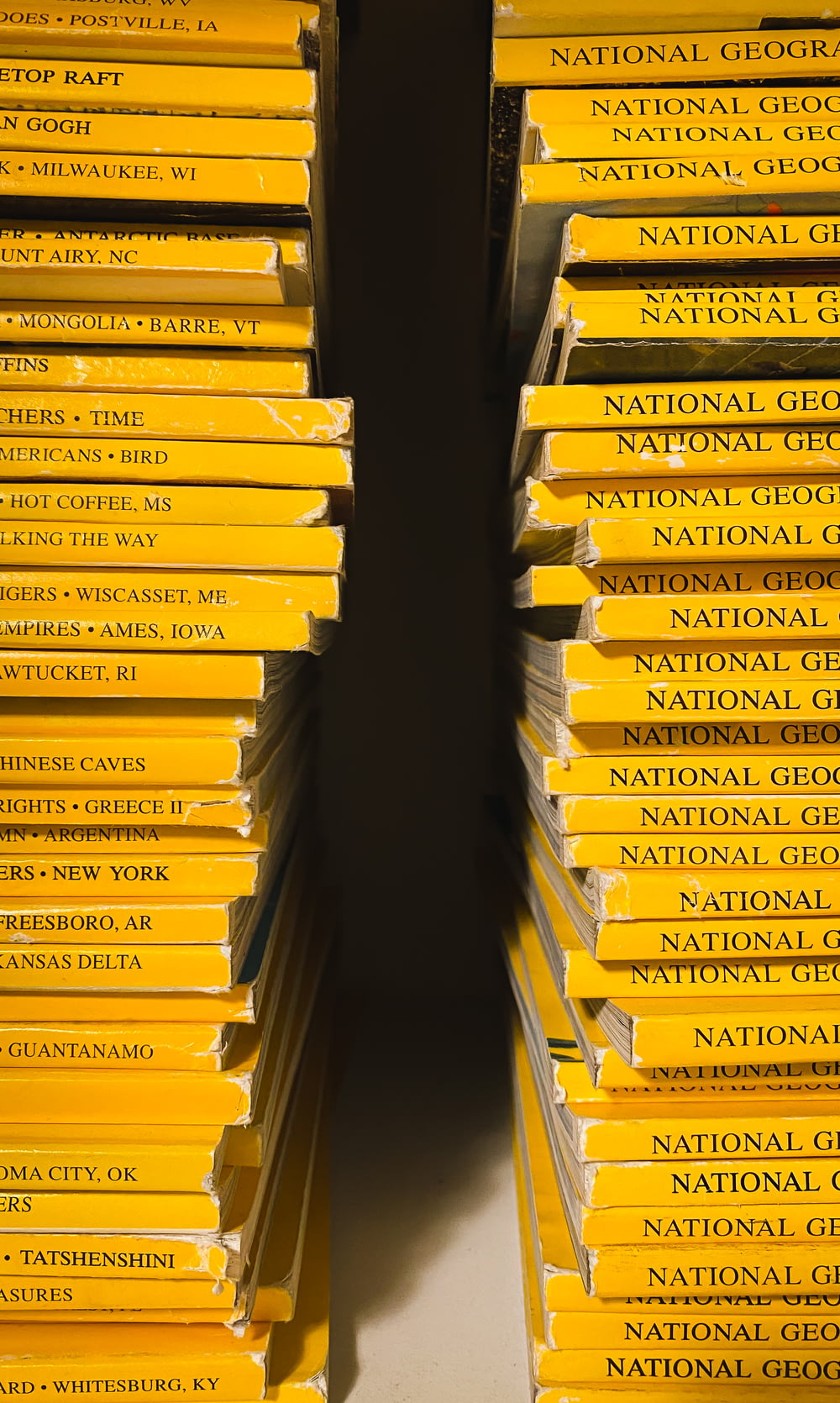 a stack of yellow books sitting on top of a table