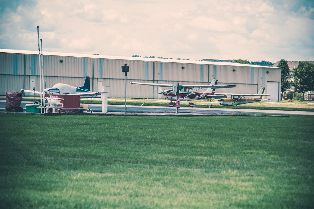 a small plane parked in front of a hangar
