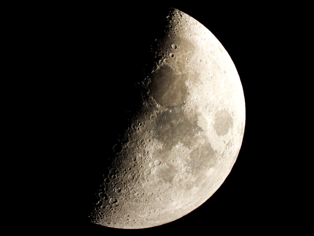 a close up of a half moon in the sky