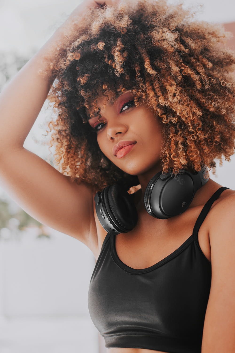 a woman with afro hair wearing headphones