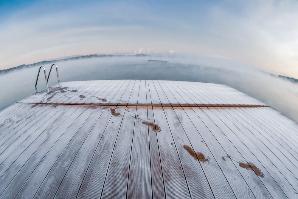a view of a wooden deck with a sky background
