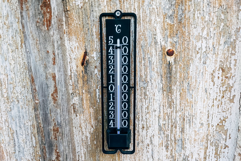 a door handle on a wooden door with numbers on it