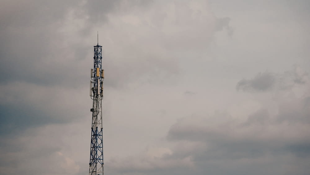 a cell phone tower on a cloudy day