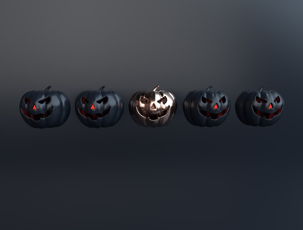 a row of halloween pumpkins with glowing eyes