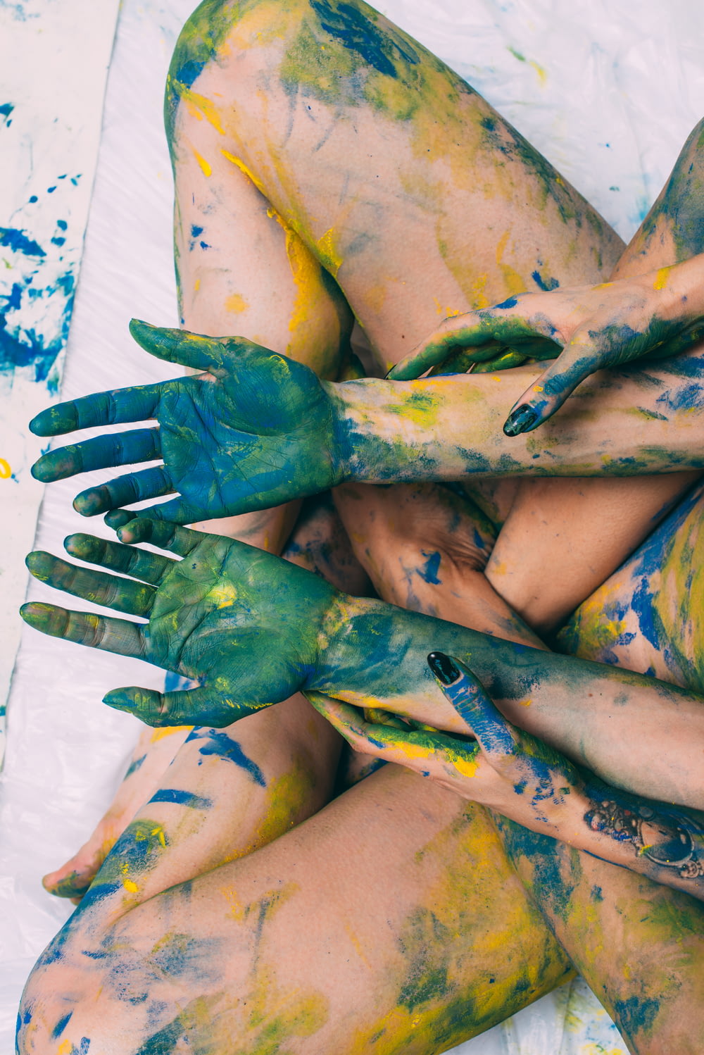a woman covered in yellow and green paint