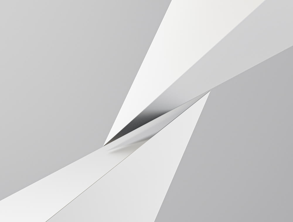 a gray and white abstract background with a curved corner