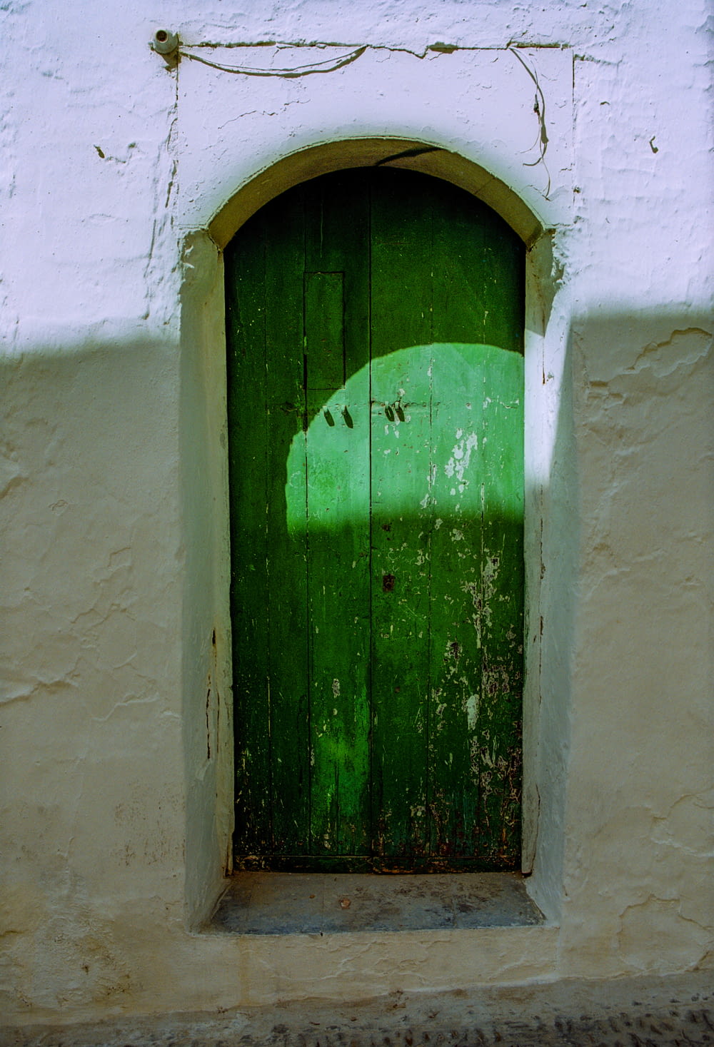 a green door in a white building