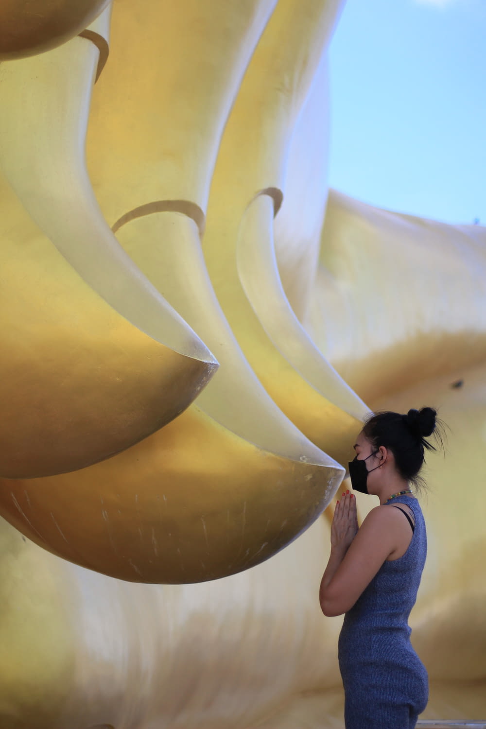a woman standing in front of a giant banana sculpture