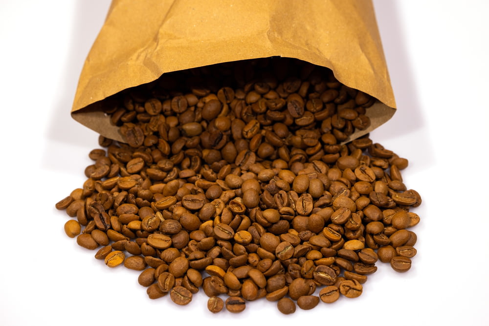a brown paper bag full of coffee beans