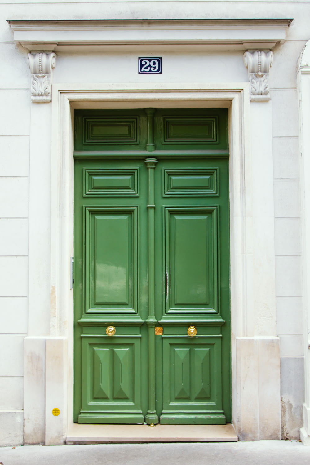 a green door with a sign on the side of it