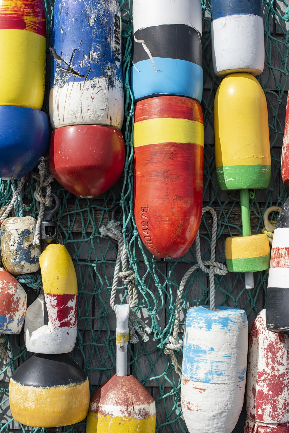 a bunch of buoys are hanging on a wall