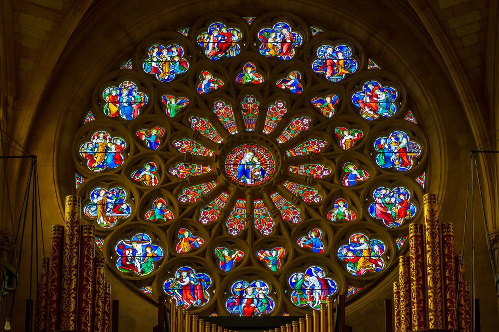 a large stained glass window inside of a church