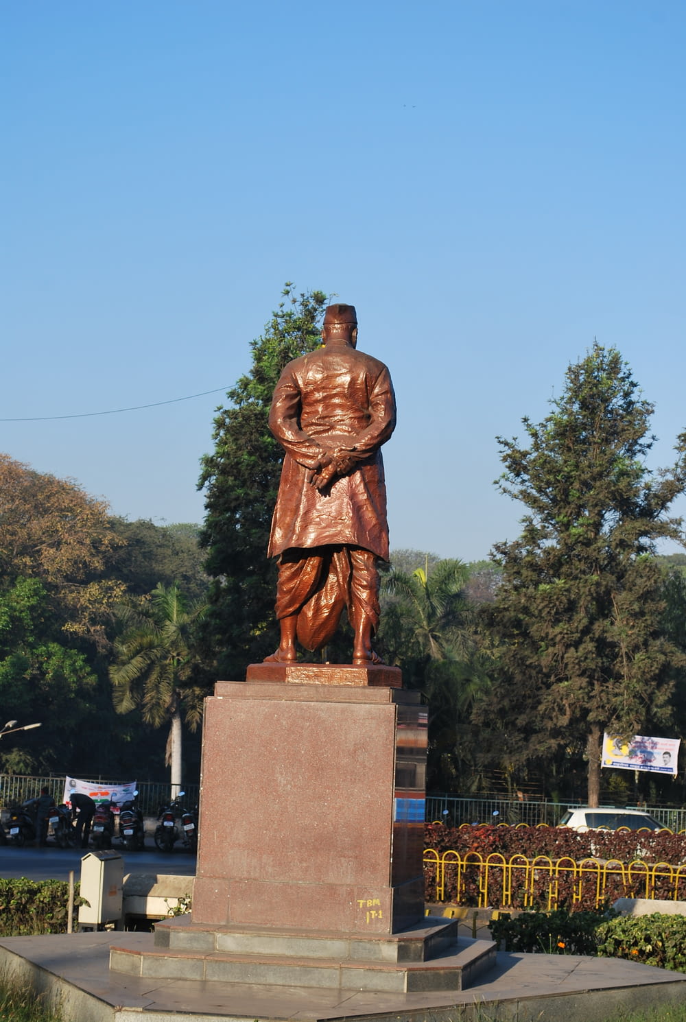 a statue of a man standing in front of a park