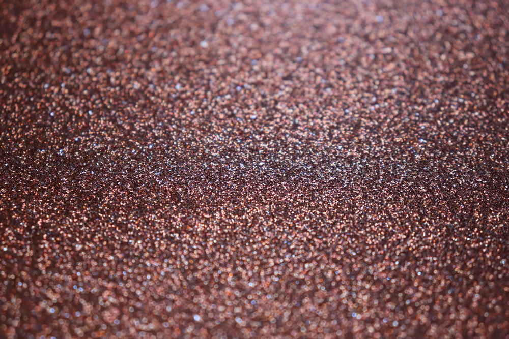 a close up of a brown glitter background