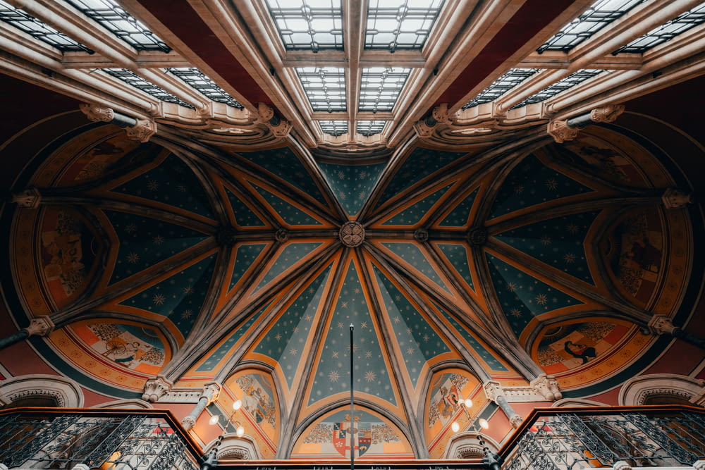 the ceiling of a church with stained glass windows