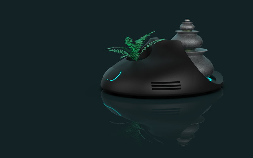 a black object with a green plant on top of it