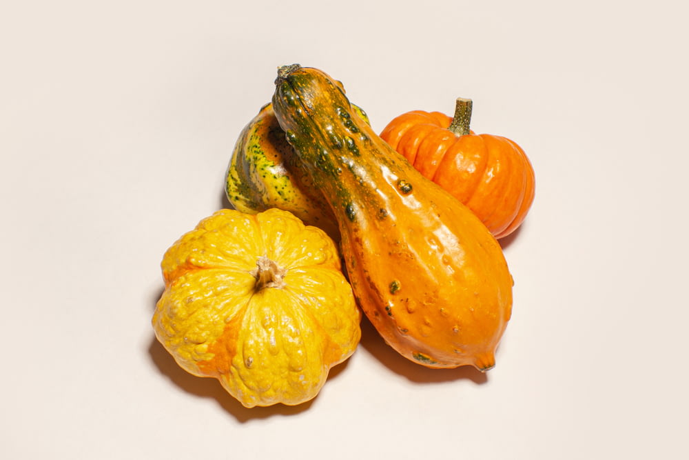 a group of pumpkins sitting on top of a white table