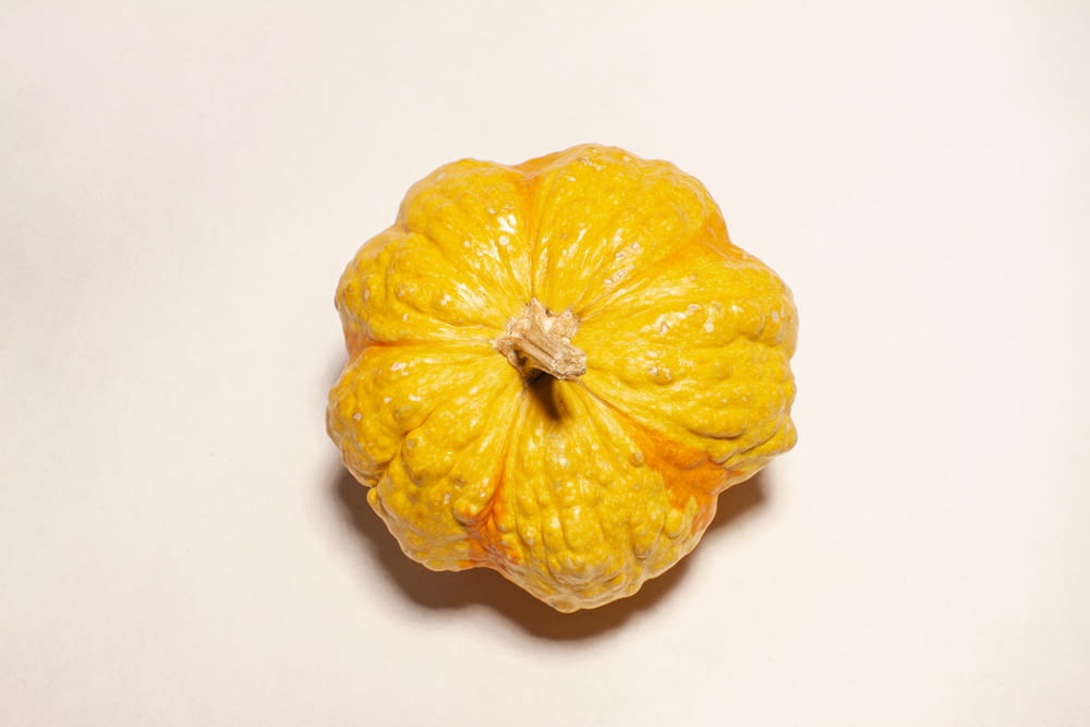 a peeled orange sitting on top of a white table
