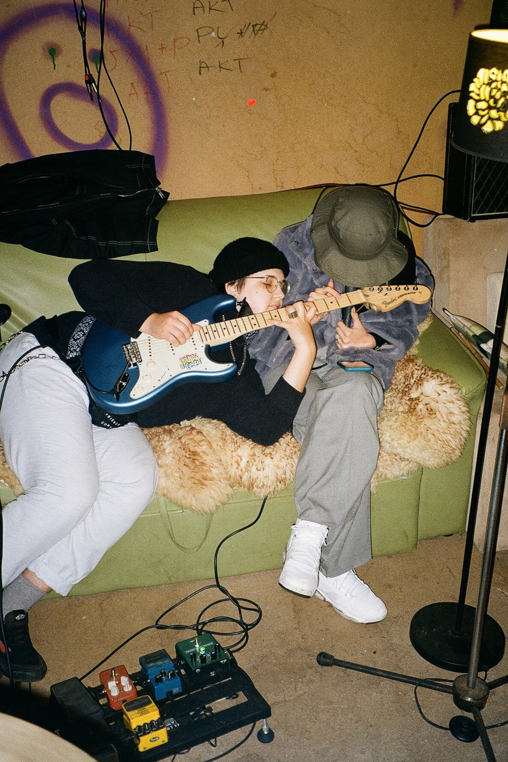 a person laying on a couch with a guitar