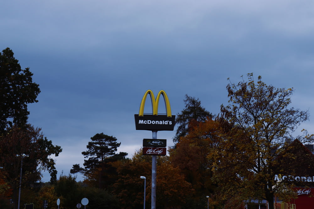 a mcdonald's sign and a mcdonald's sign on a cloudy day