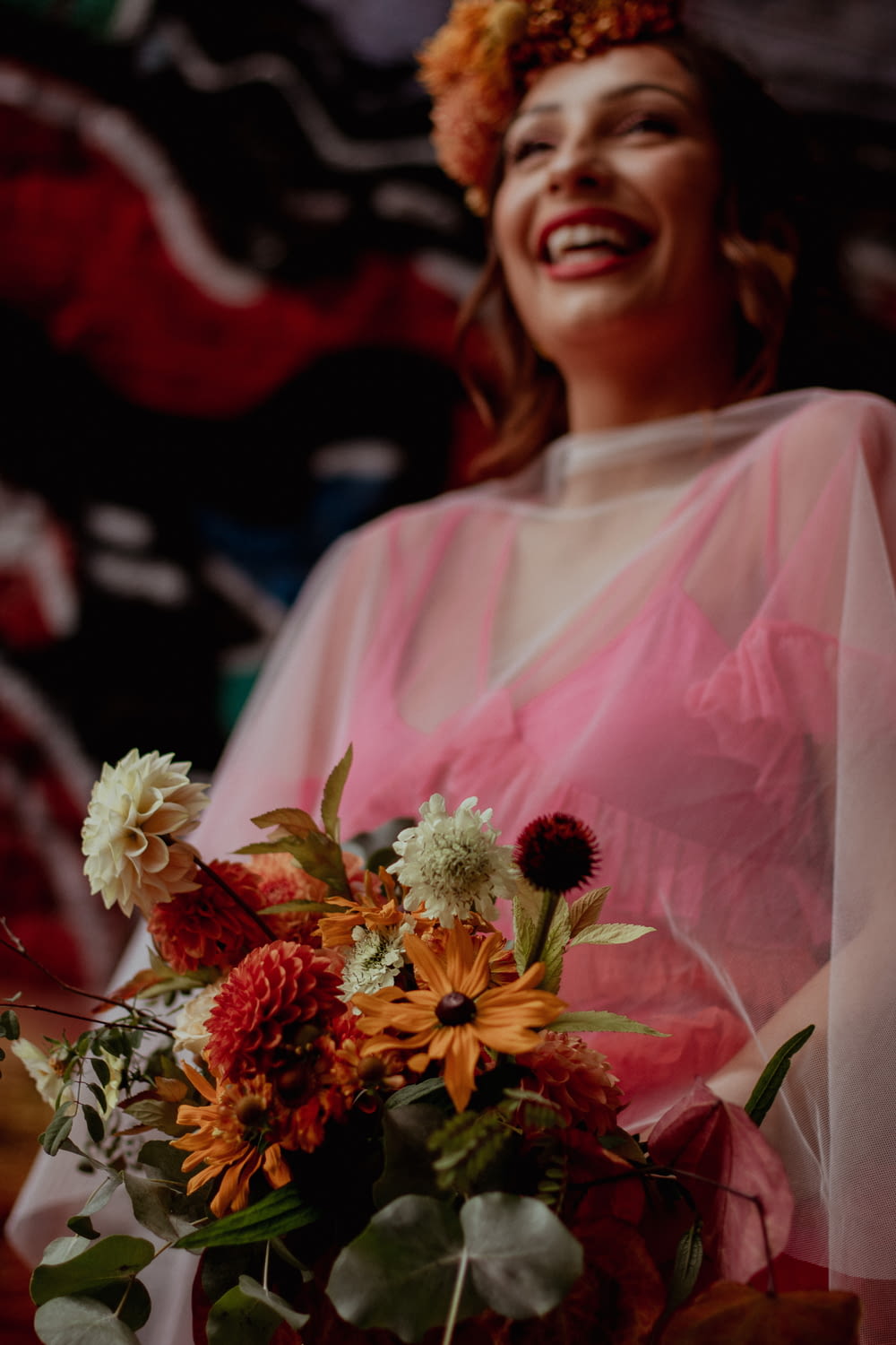 a woman in a pink dress holding a bouquet of flowers
