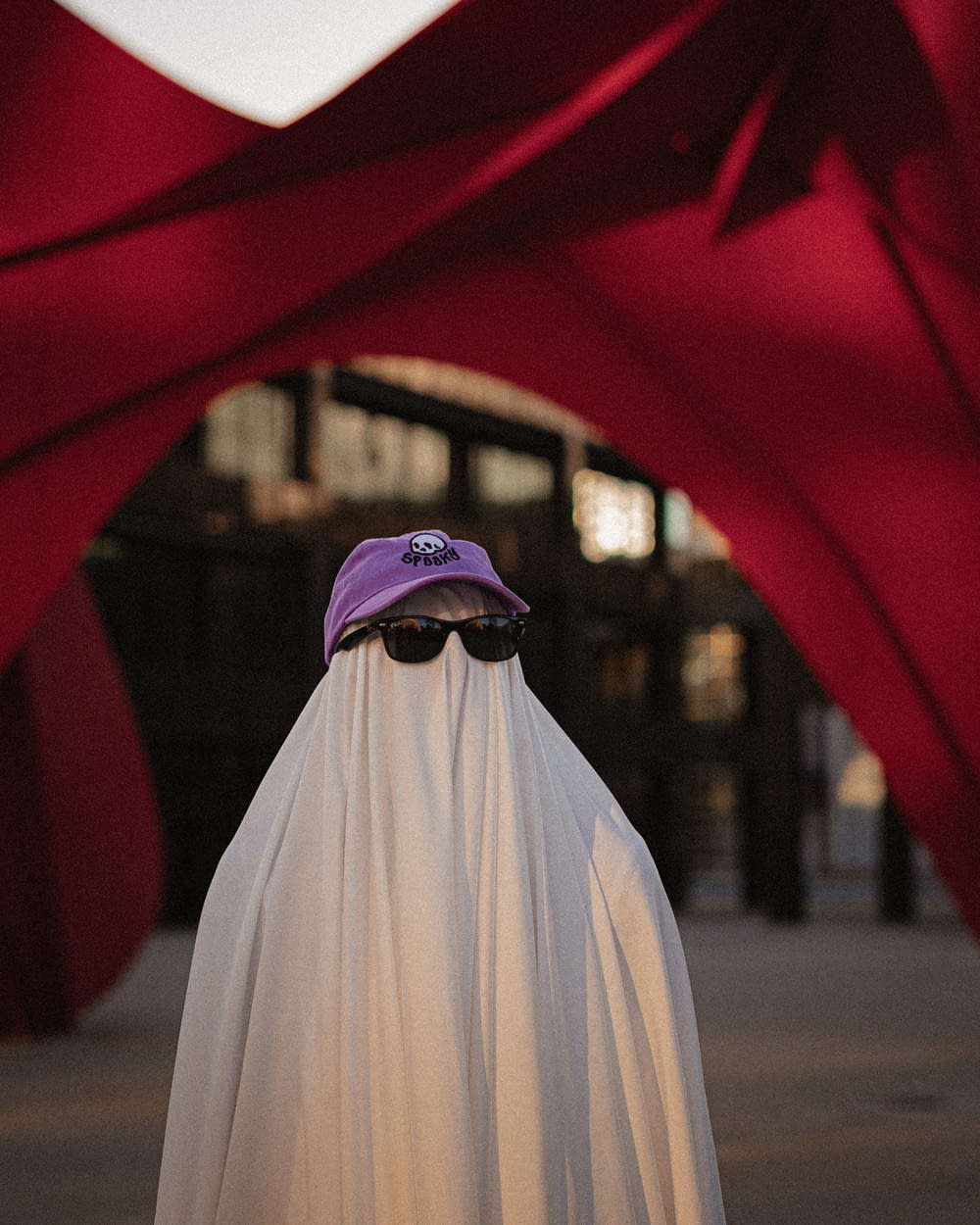 a person wearing a white cape and a purple hat