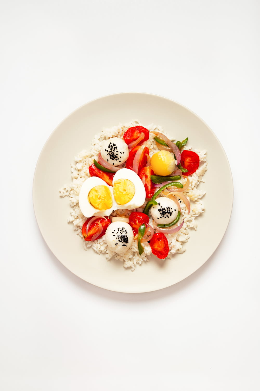 a white plate topped with eggs and vegetables