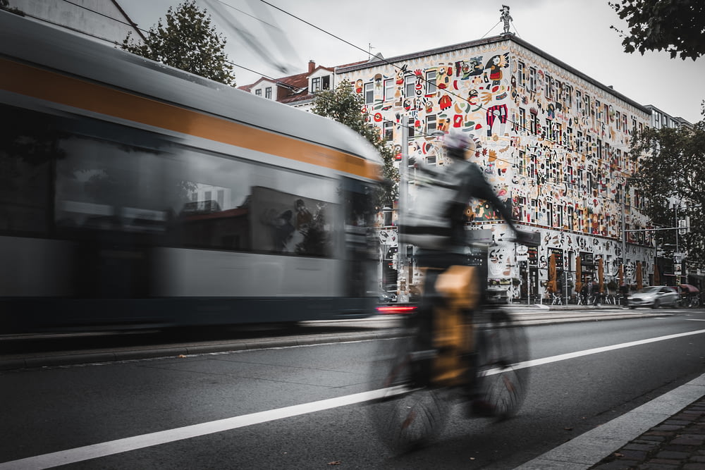 a person riding a bike on a city street
