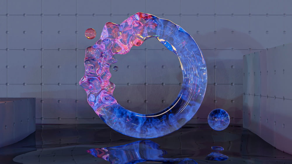 a sculpture of a circular object on a reflective surface