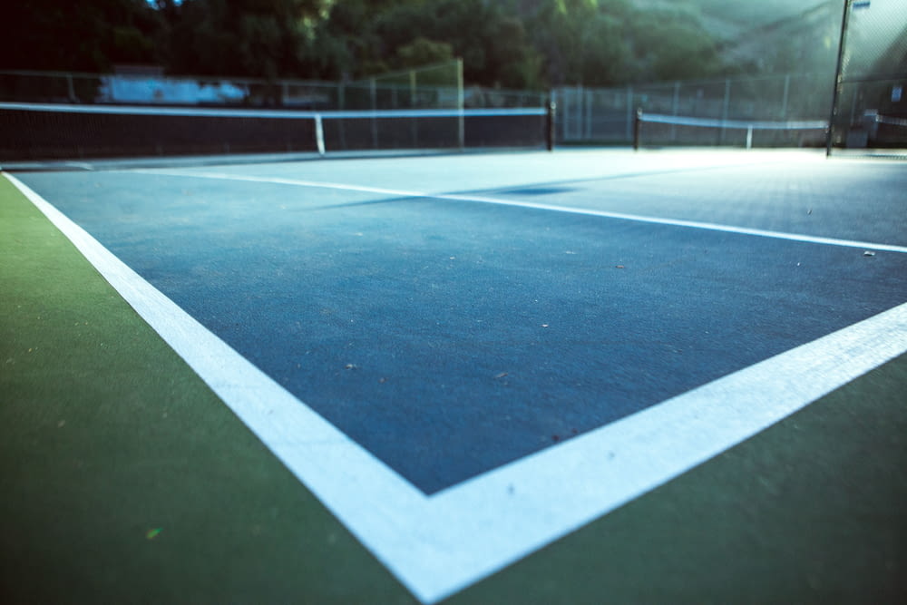 a tennis court with a blue and white tennis court