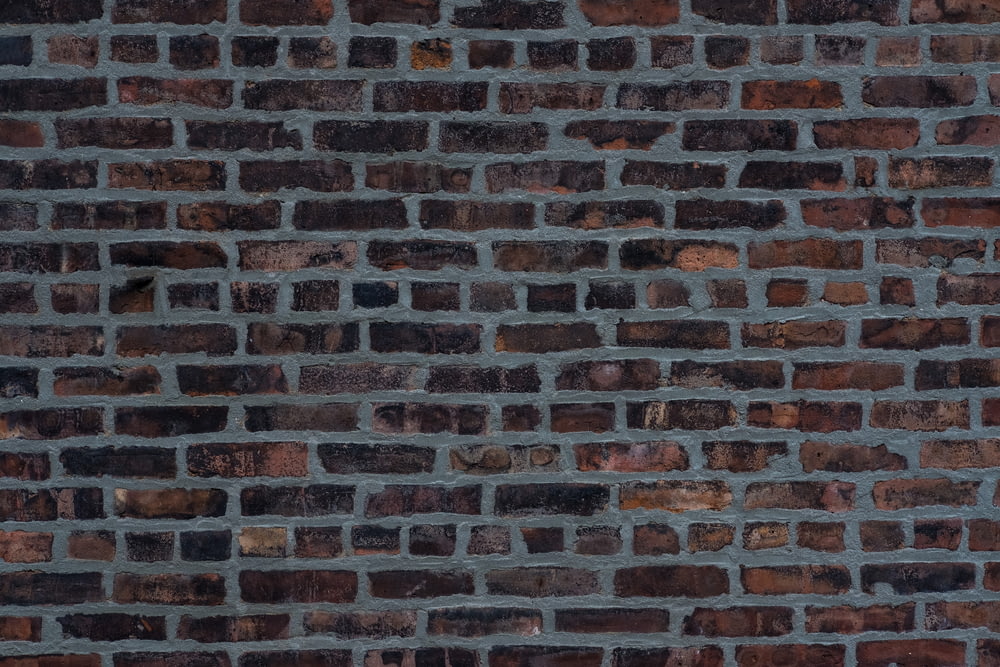 a brick wall is shown with a red stop sign