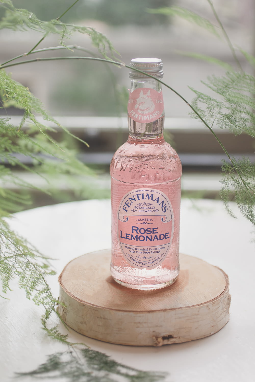 a bottle of rose lemonade sitting on top of a table
