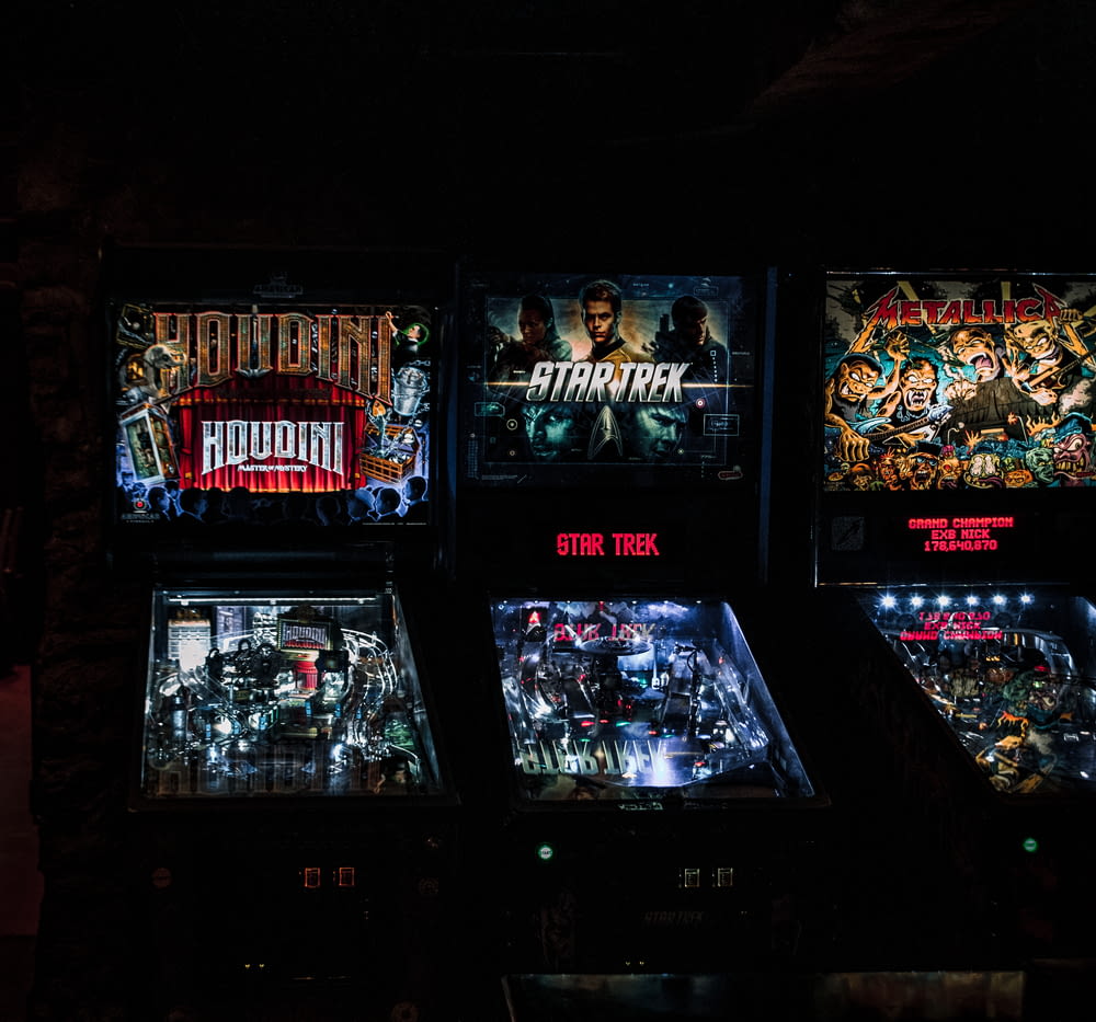 a row of pinball machines sitting next to each other