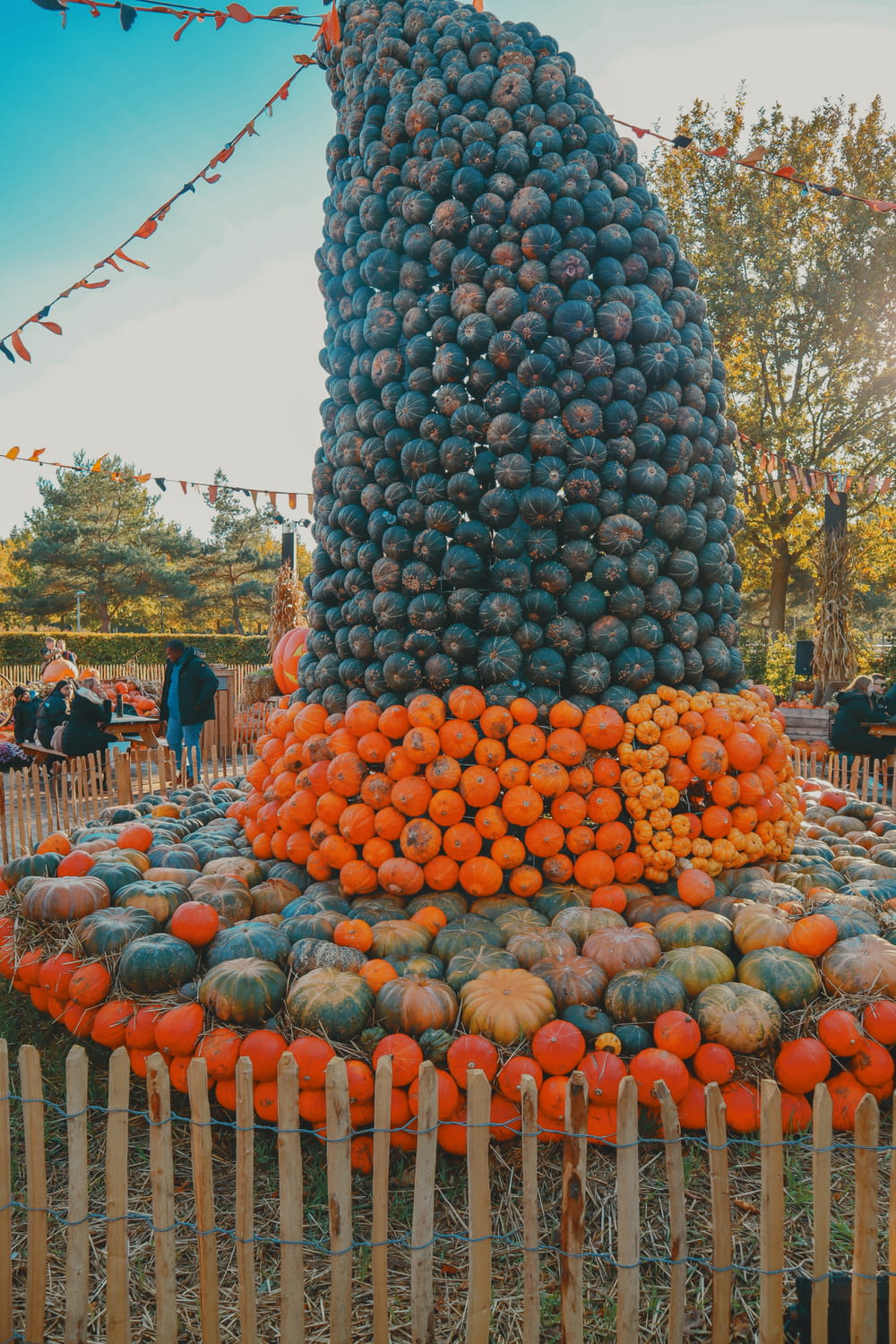 a large pile of fruit sitting on top of a wooden fence
