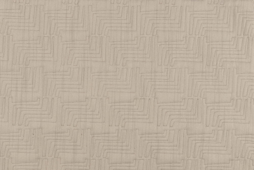 a close up of a white quilted material