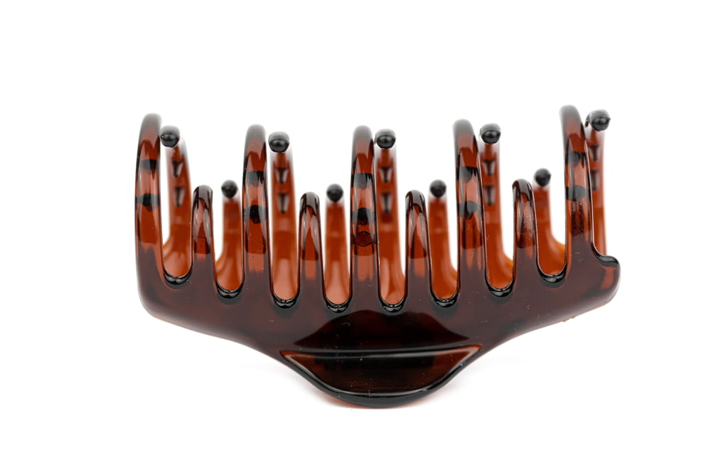 a close up of a hair comb on a white background