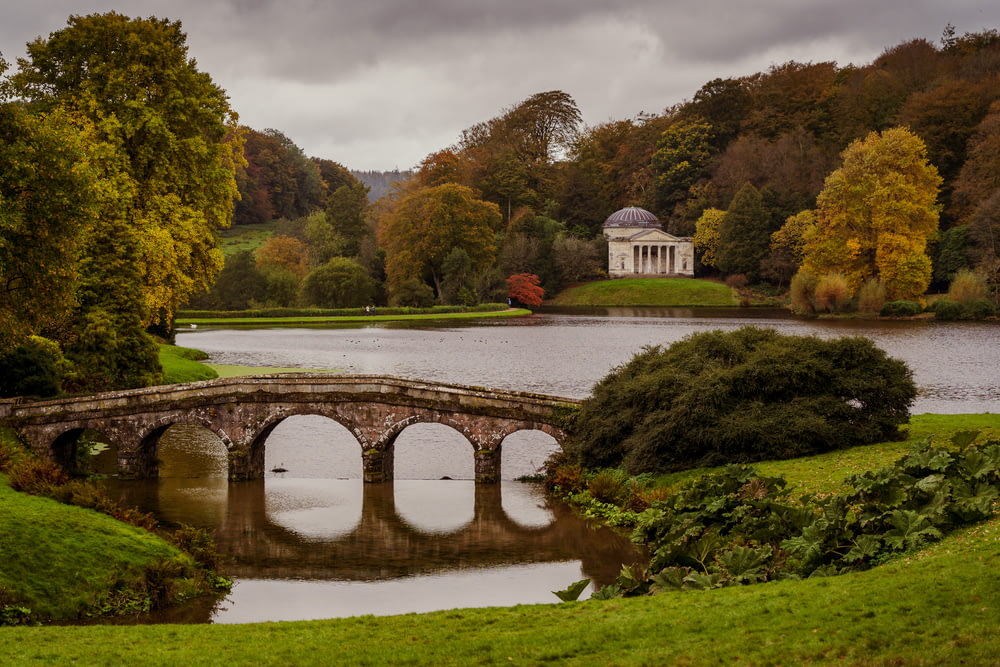 a train crossing Stourhead over a body of water