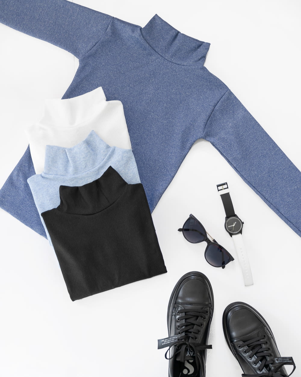 a pair of black shoes and a blue sweater