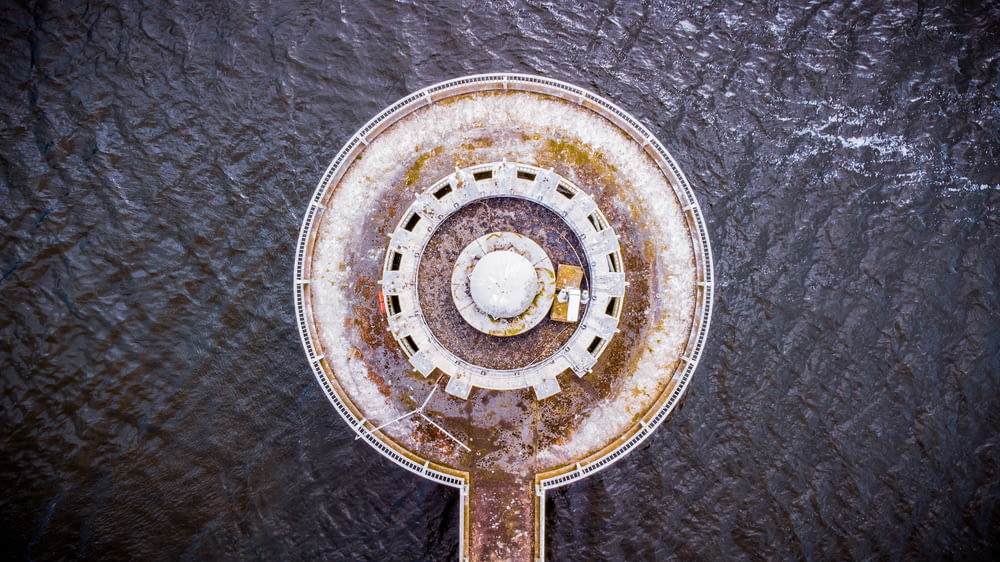 an aerial view of a circular structure in the water