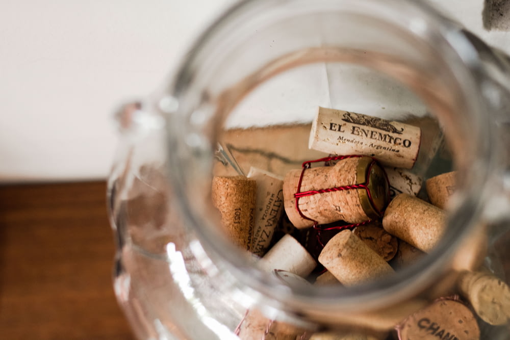 a glass jar filled with lots of wine corks