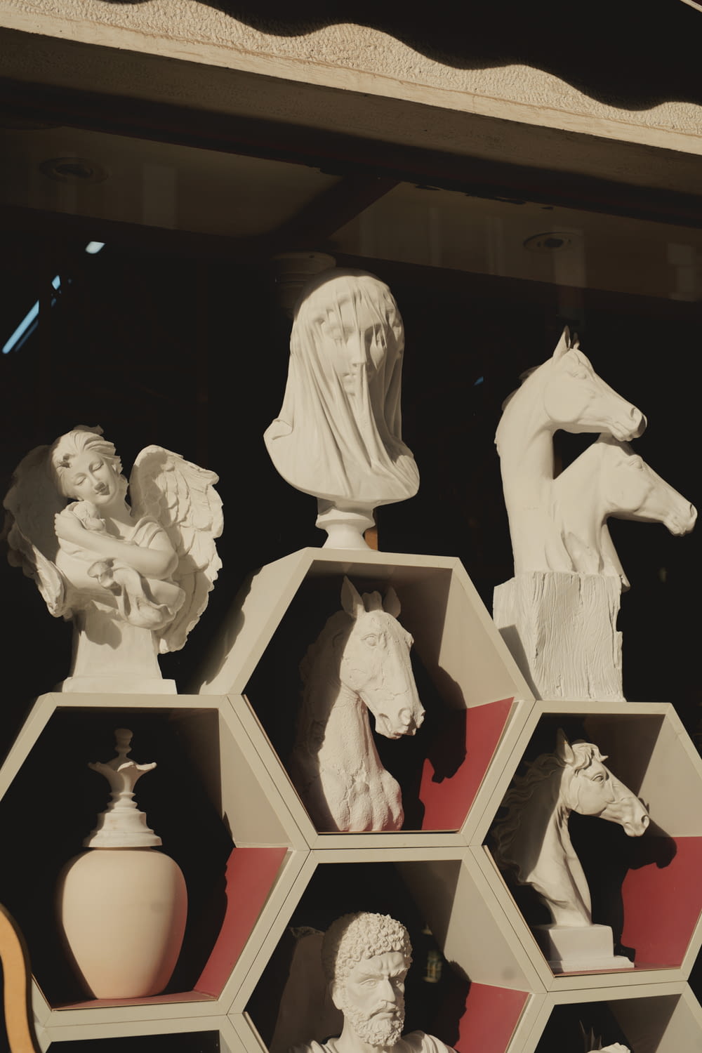 a bunch of statues are on display in a window