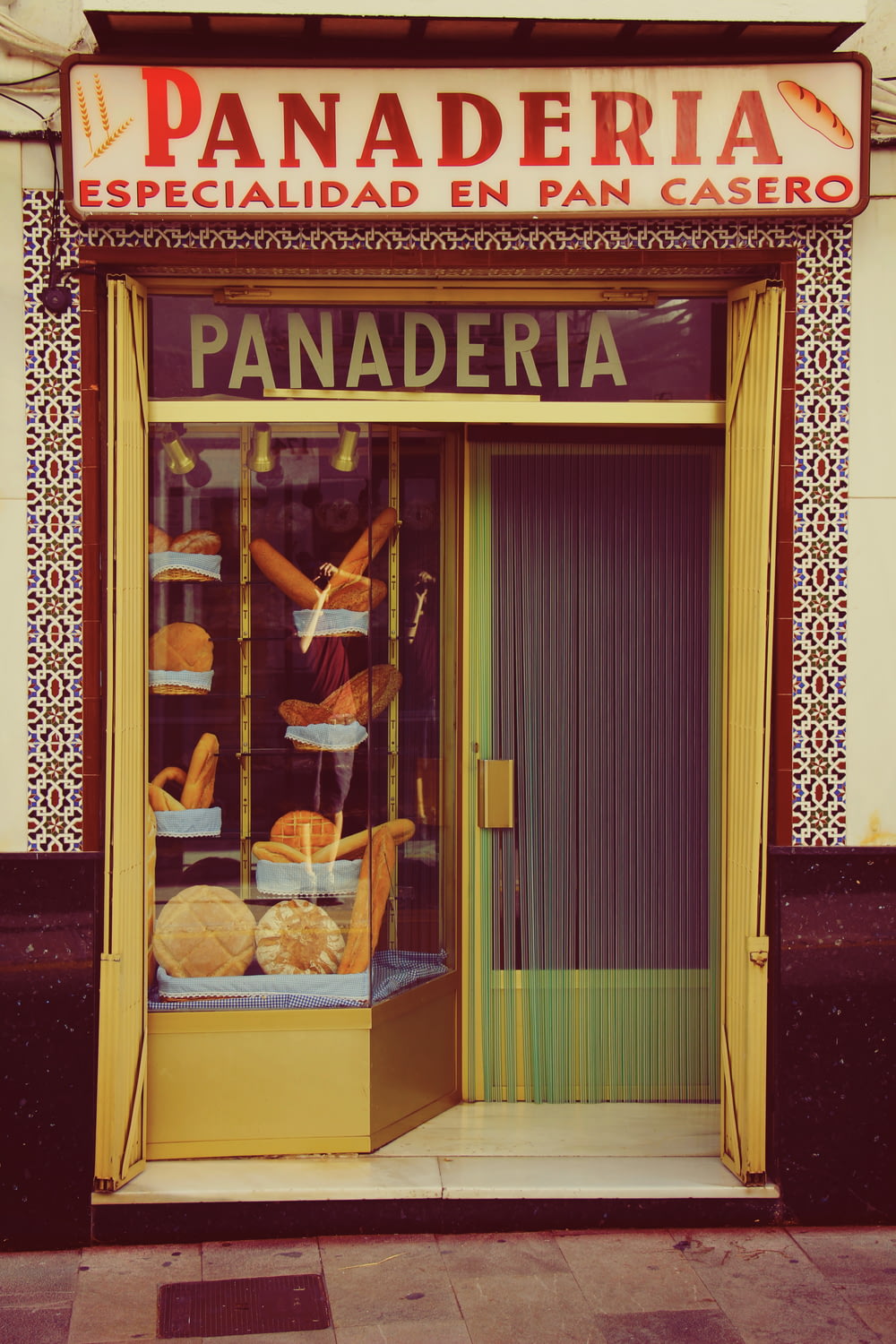 a store front with a display of baked goods