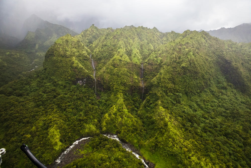 an aerial view of a lush green mountain range