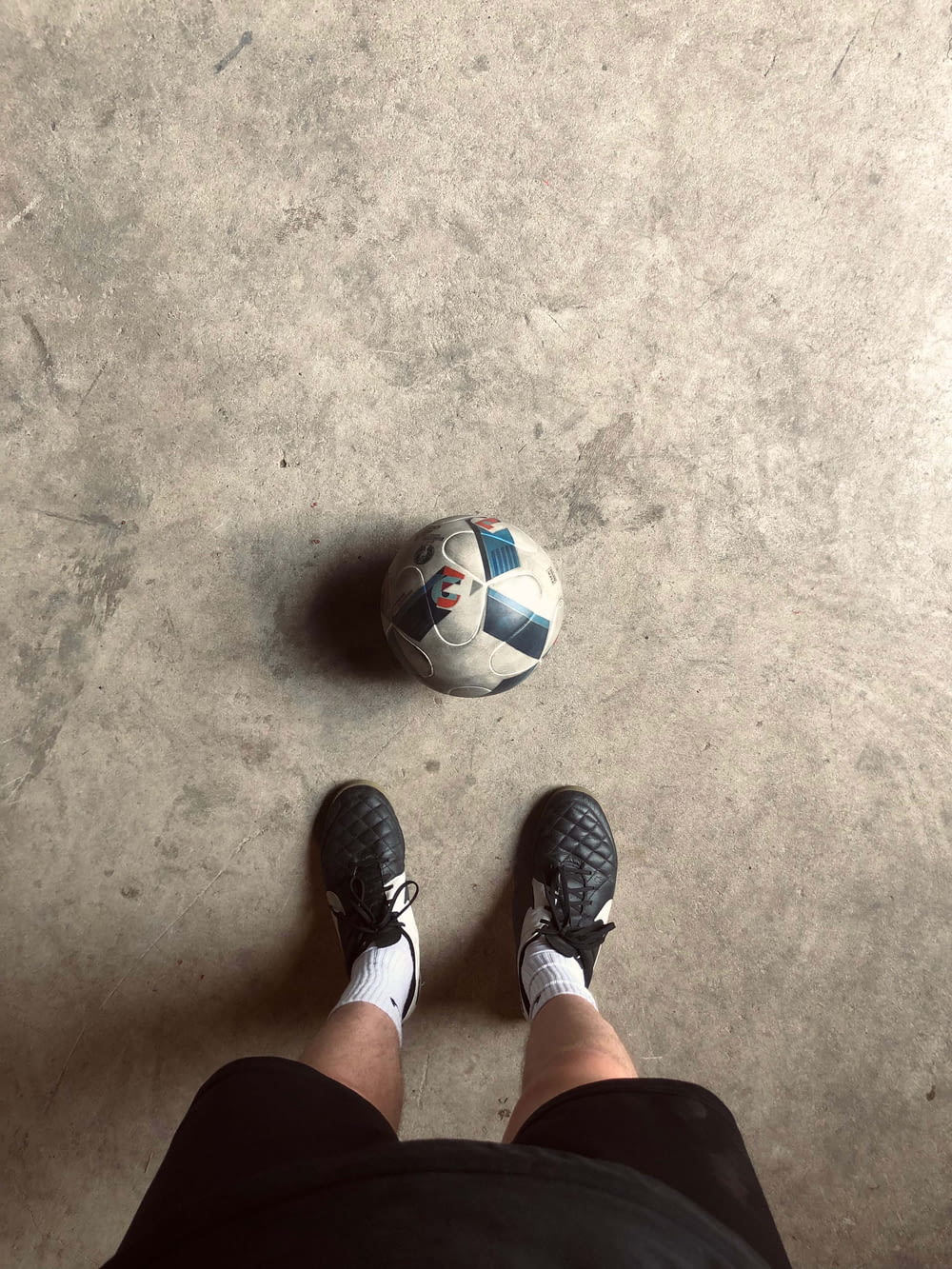 a person standing in front of a soccer ball