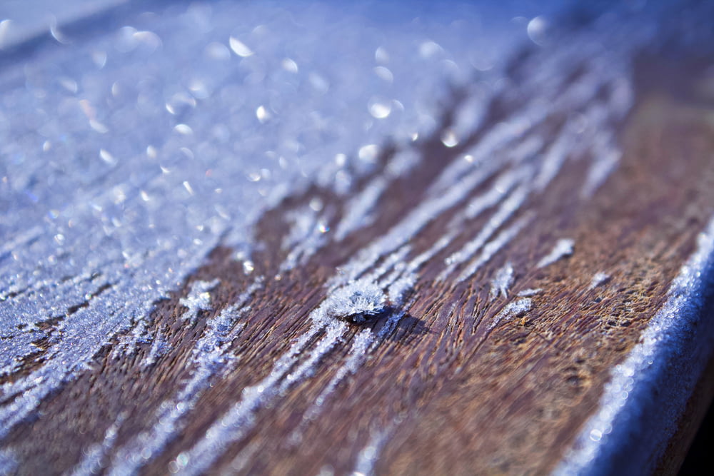 a close up of a wooden surface with drops of water on it