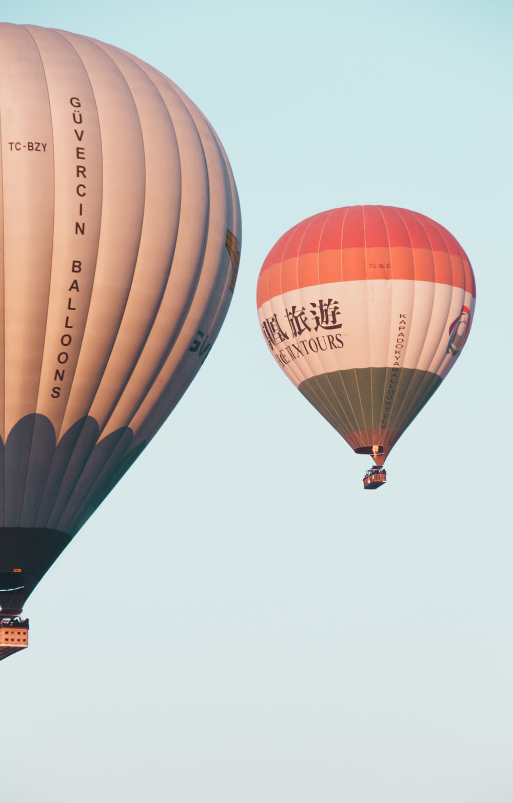 two hot air balloons flying in the sky